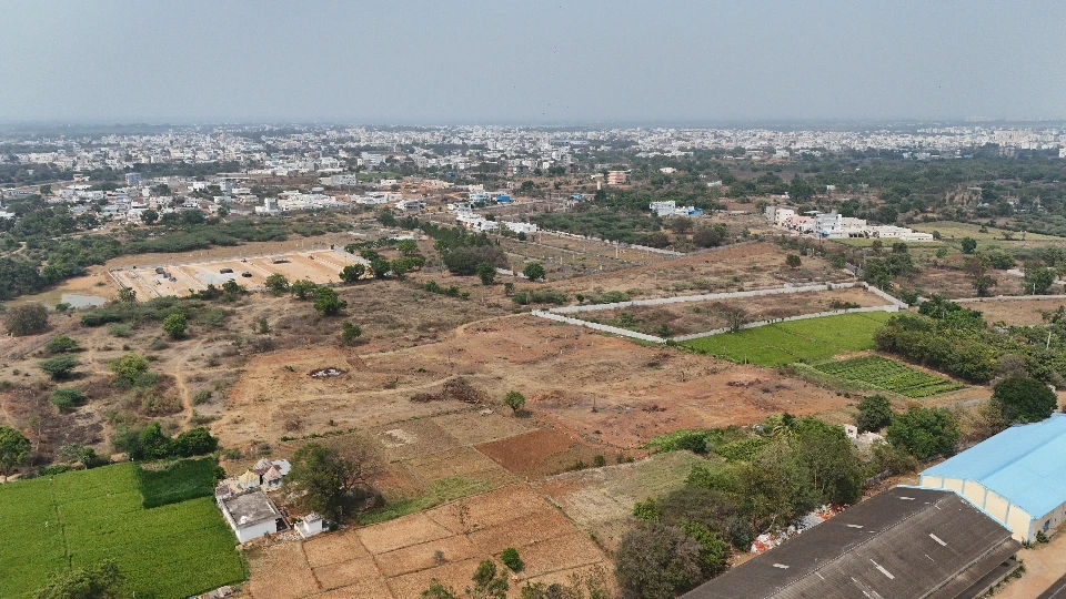 Aerial view of open plots and residential development in Sangareddy near NH-65